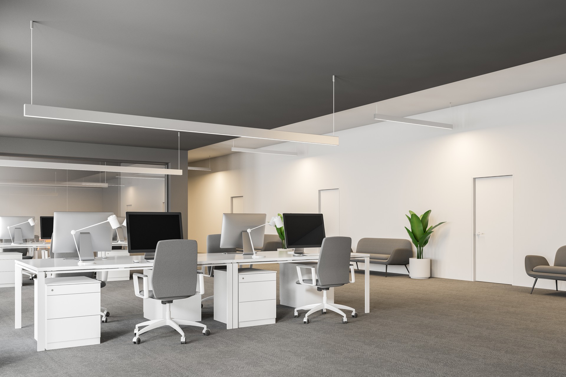 Gray and white office workplace with sofas